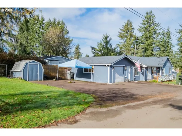 a front view of a house with a garden and pathway