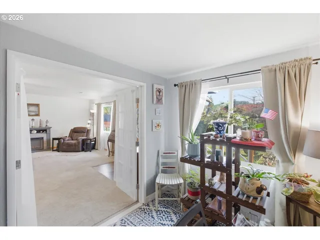 a view of a livingroom with furniture and a window