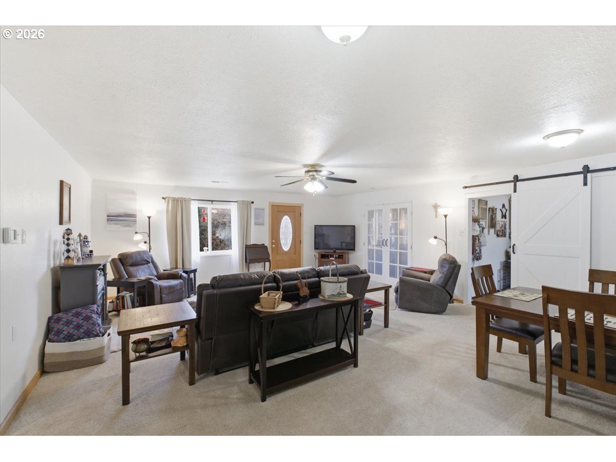 2295 Cedar Street Sweet Home, OR 97386 - Photo 7 of 32 a living room with furniture and a flat screen tv