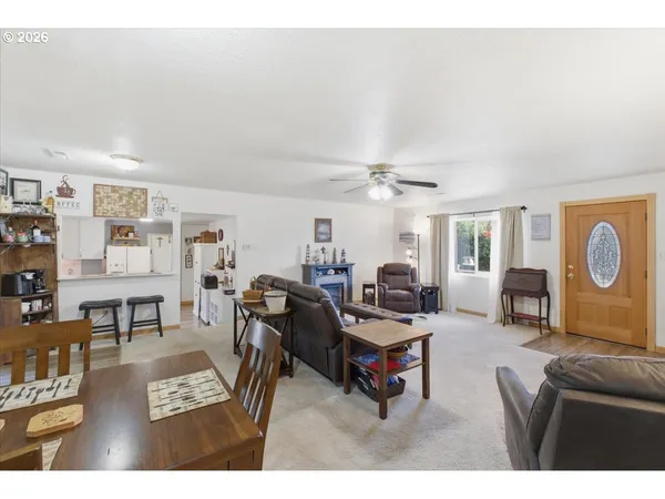 a living room with furniture a rug and white walls