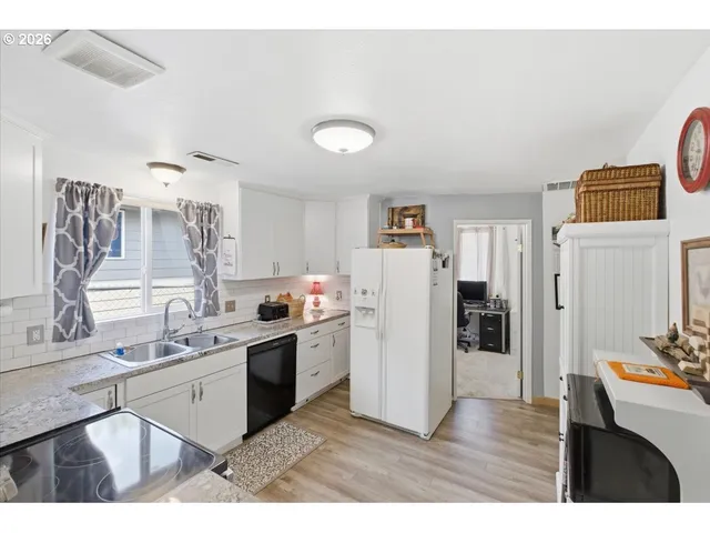 a kitchen with a sink appliances and cabinets