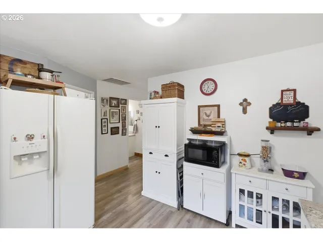 a hallway with cabinets and wooden floor