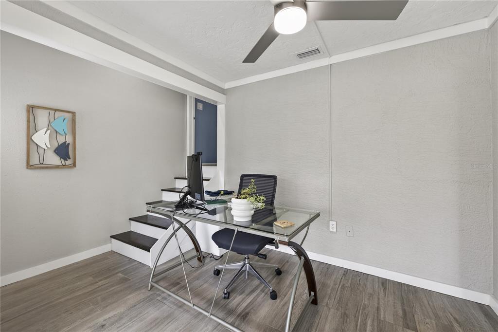 5851 Rio Drive New Port Richey, FL 34652 - Photo 13 of 50 a view of a workspace with furniture and wooden floor