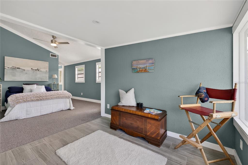 5851 Rio Drive New Port Richey, FL 34652 - Photo 19 of 50 a bedroom with a bed and chair