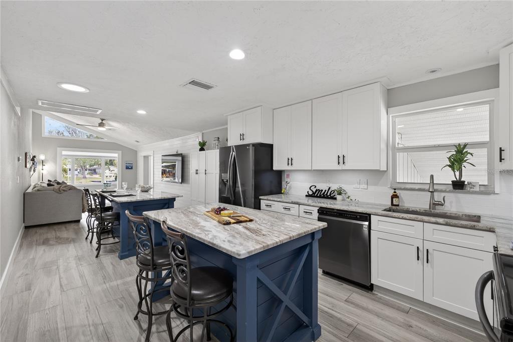5851 Rio Drive New Port Richey, FL 34652 - Photo 2 of 50 a kitchen with a table chairs sink and cabinets