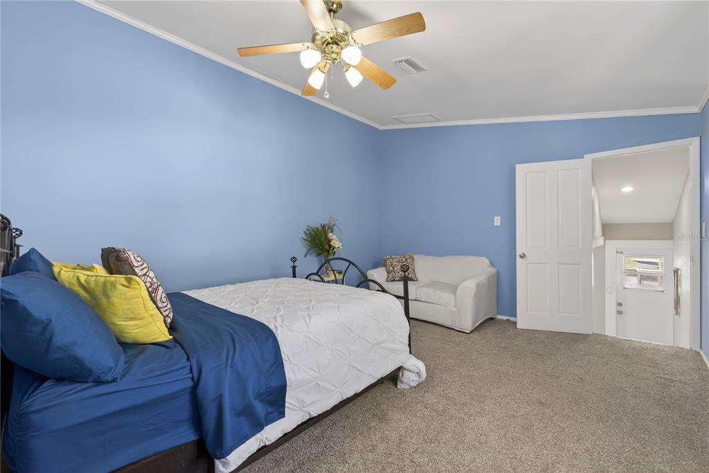 5851 Rio Drive New Port Richey, FL 34652 - Photo 27 of 50 a bedroom with bed and a chandelier