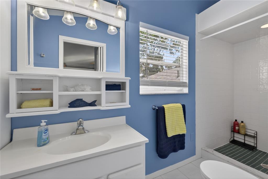 5851 Rio Drive New Port Richey, FL 34652 - Photo 29 of 50 a bathroom with a sink vanity mirror and toilet
