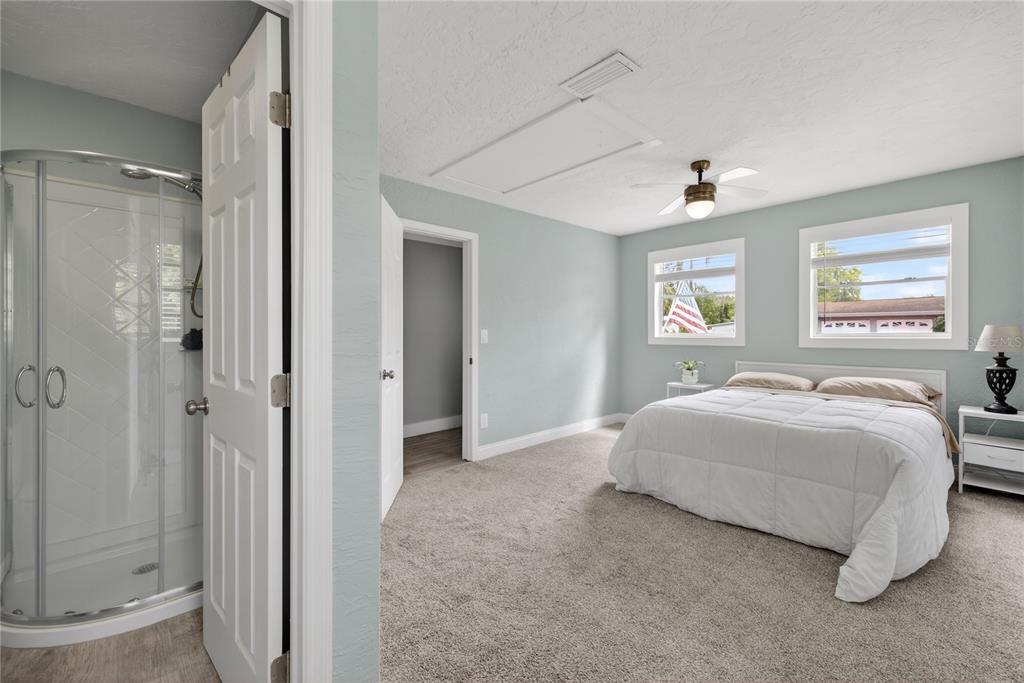 5851 Rio Drive New Port Richey, FL 34652 - Photo 31 of 50 a spacious bedroom with a bed and a painting on the wall