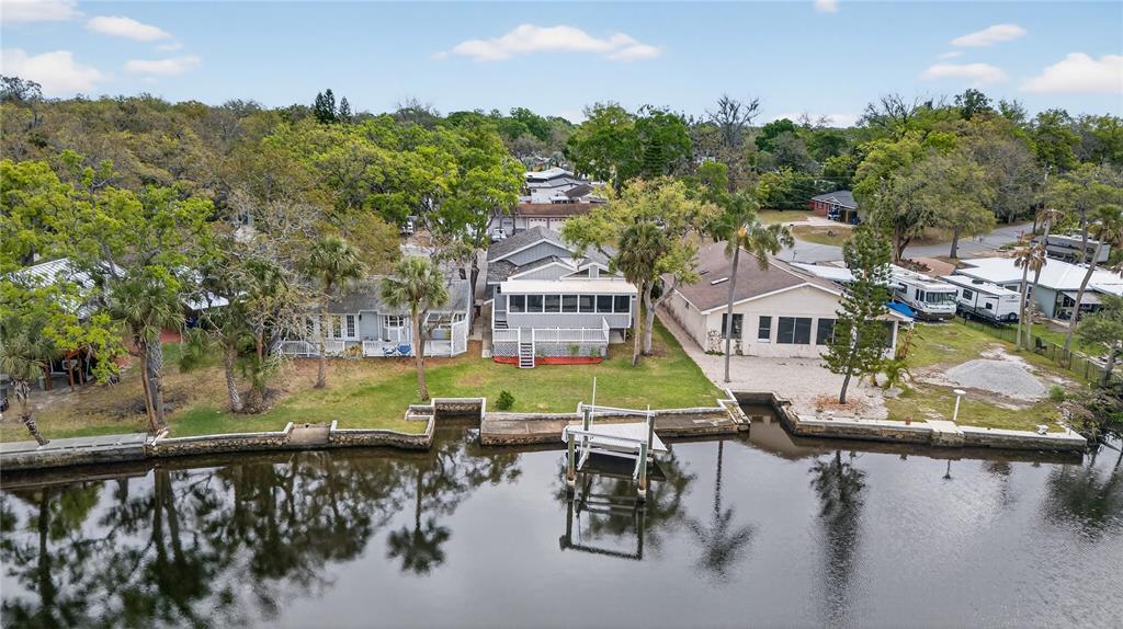 5851 Rio Drive New Port Richey, FL 34652 - Photo 47 of 50 a view of a lake with a house swimming pool and outdoor space