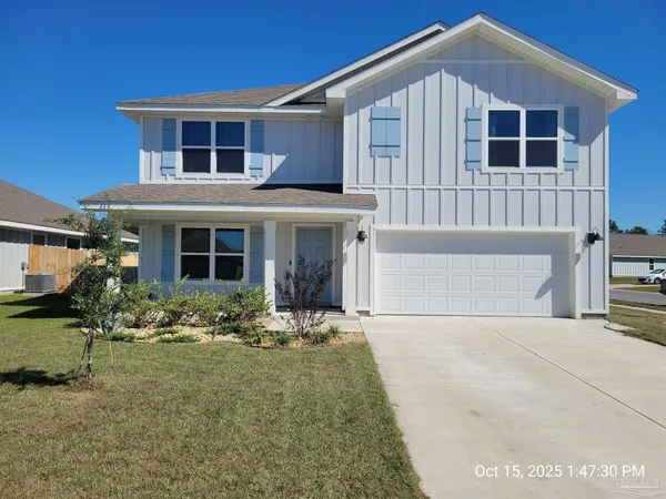 a front view of a house with yard and seating space
