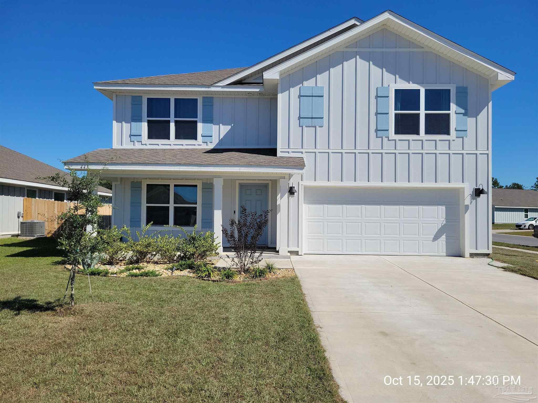 a front view of a house with yard and seating space
