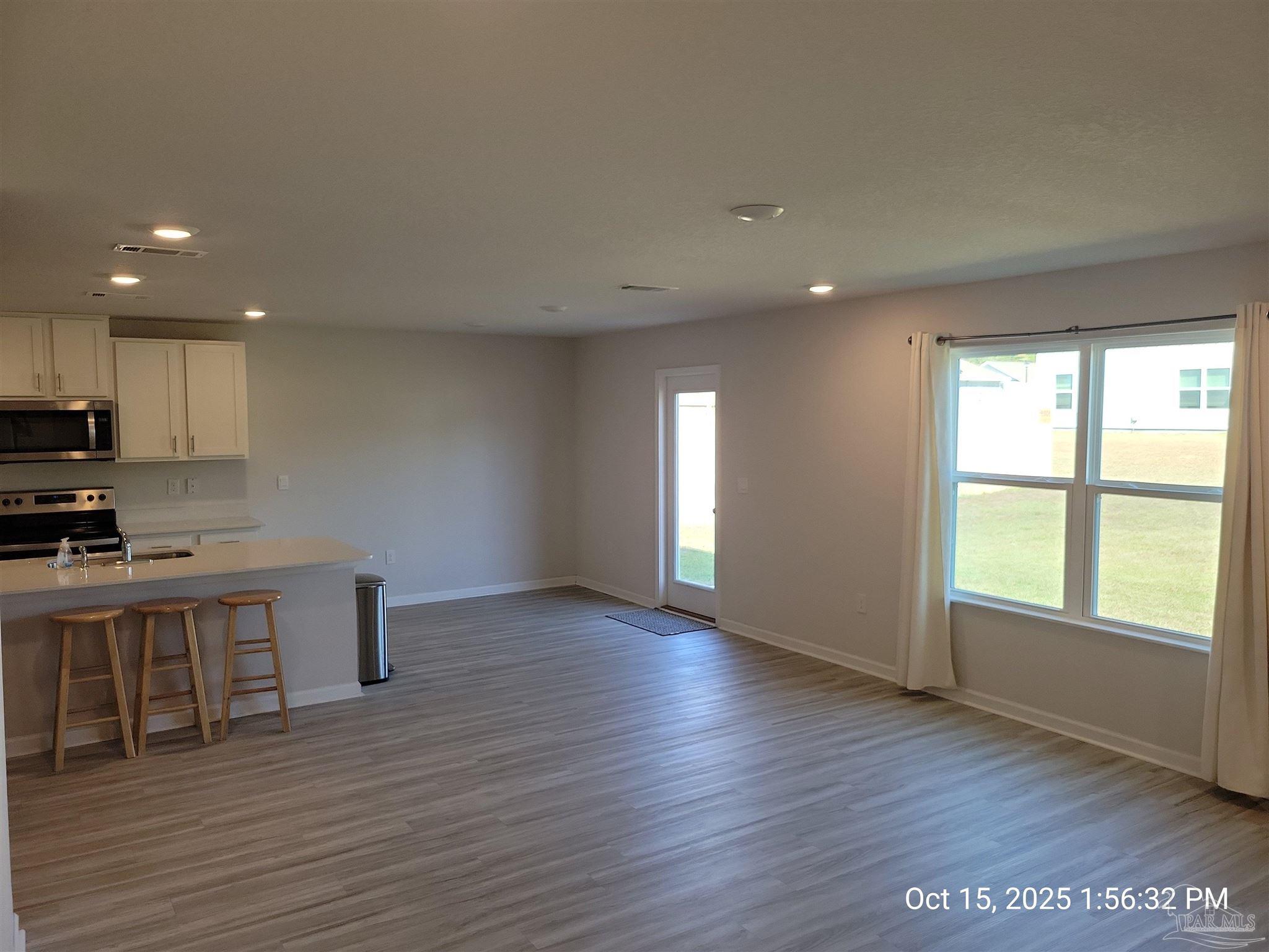 441 Scarborough Street Crestview, FL 32539 - Photo 4 of 13 a view of a kitchen with cabinets and wooden floor