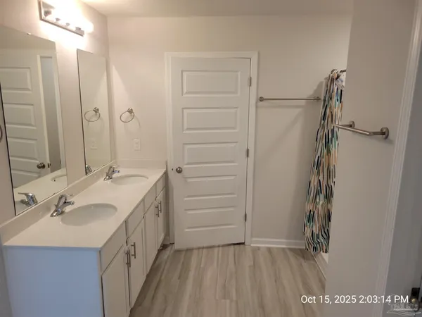 a bathroom with a double vanity sink and mirror