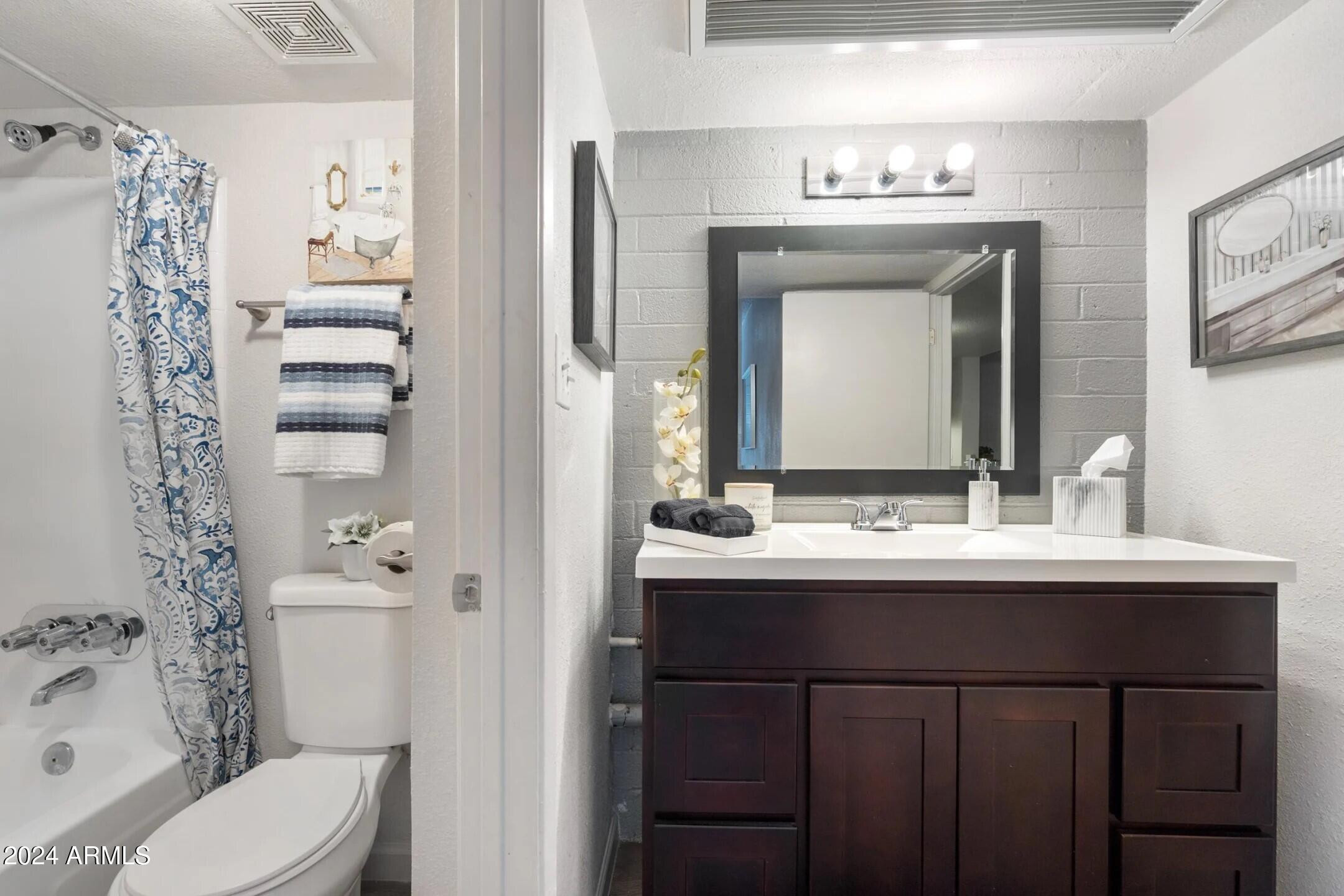 1601 West Camelback Road, Unit A10AW Phoenix, AZ 85015 - Photo 10 of 23 a bathroom with a sink and a mirror