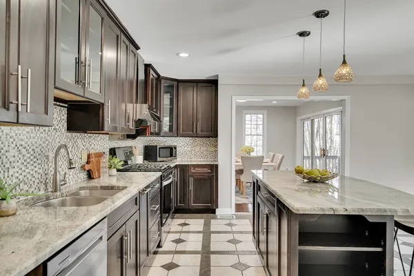 a kitchen with stainless steel appliances granite countertop a stove and a refrigerator