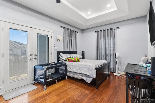 a bedroom with furniture and wooden floor