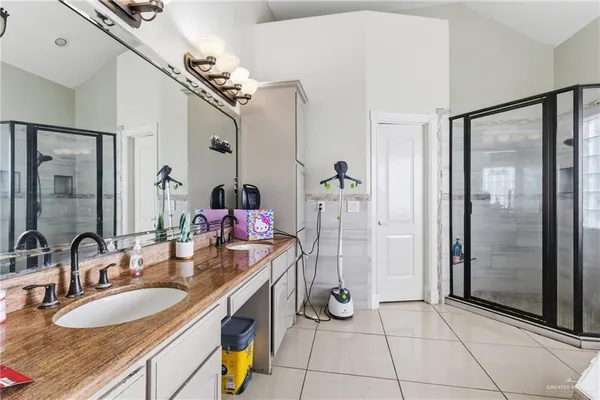 a bathroom with a sink double vanity and a mirror
