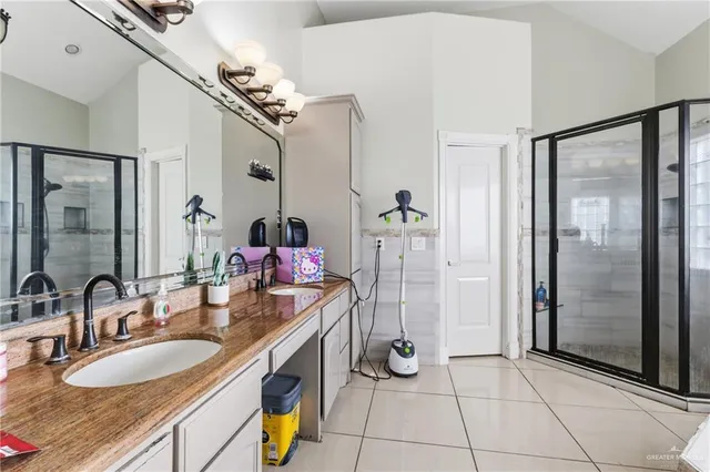 a bathroom with a sink double vanity and a mirror