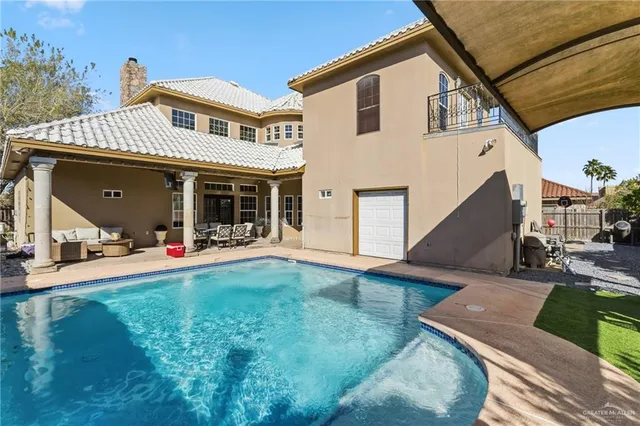 a view of a house with patio and a yard