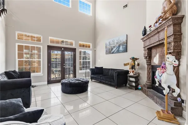 a living room with furniture a flat screen tv and a floor to ceiling window