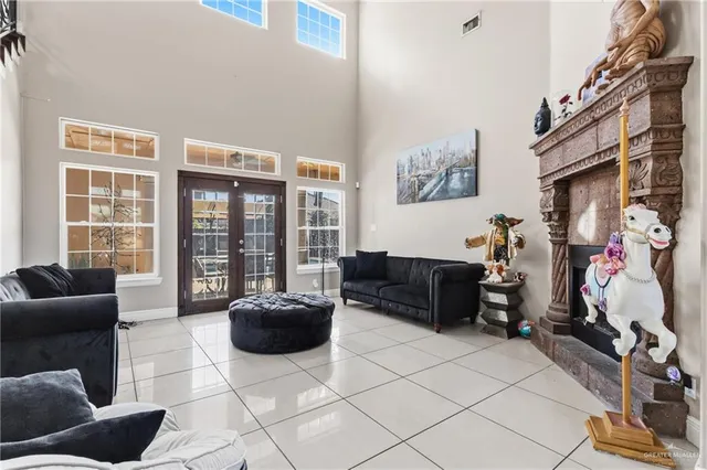 a living room with furniture a flat screen tv and a floor to ceiling window