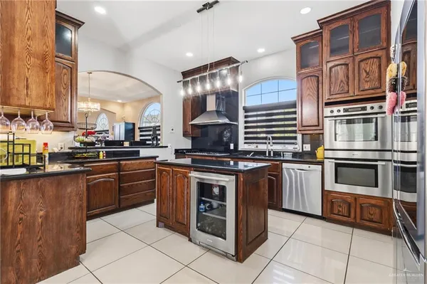a kitchen with stainless steel appliances granite countertop a stove and a sink