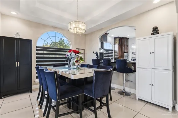 a view of a dining room with furniture and chandelier