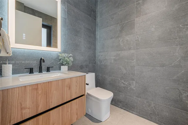 a bathroom with a sink a toilet and mirror