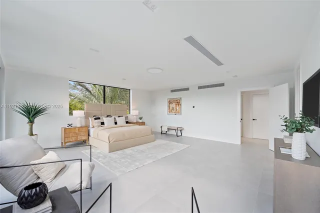 a living room with furniture and potted plants