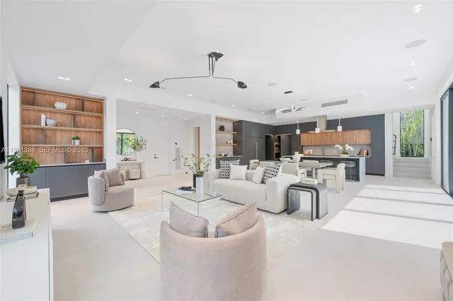 a living room with furniture and kitchen view