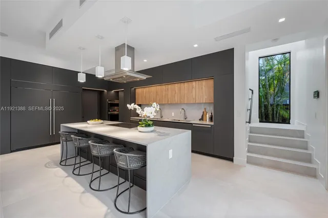 a kitchen with stainless steel appliances a table and chairs