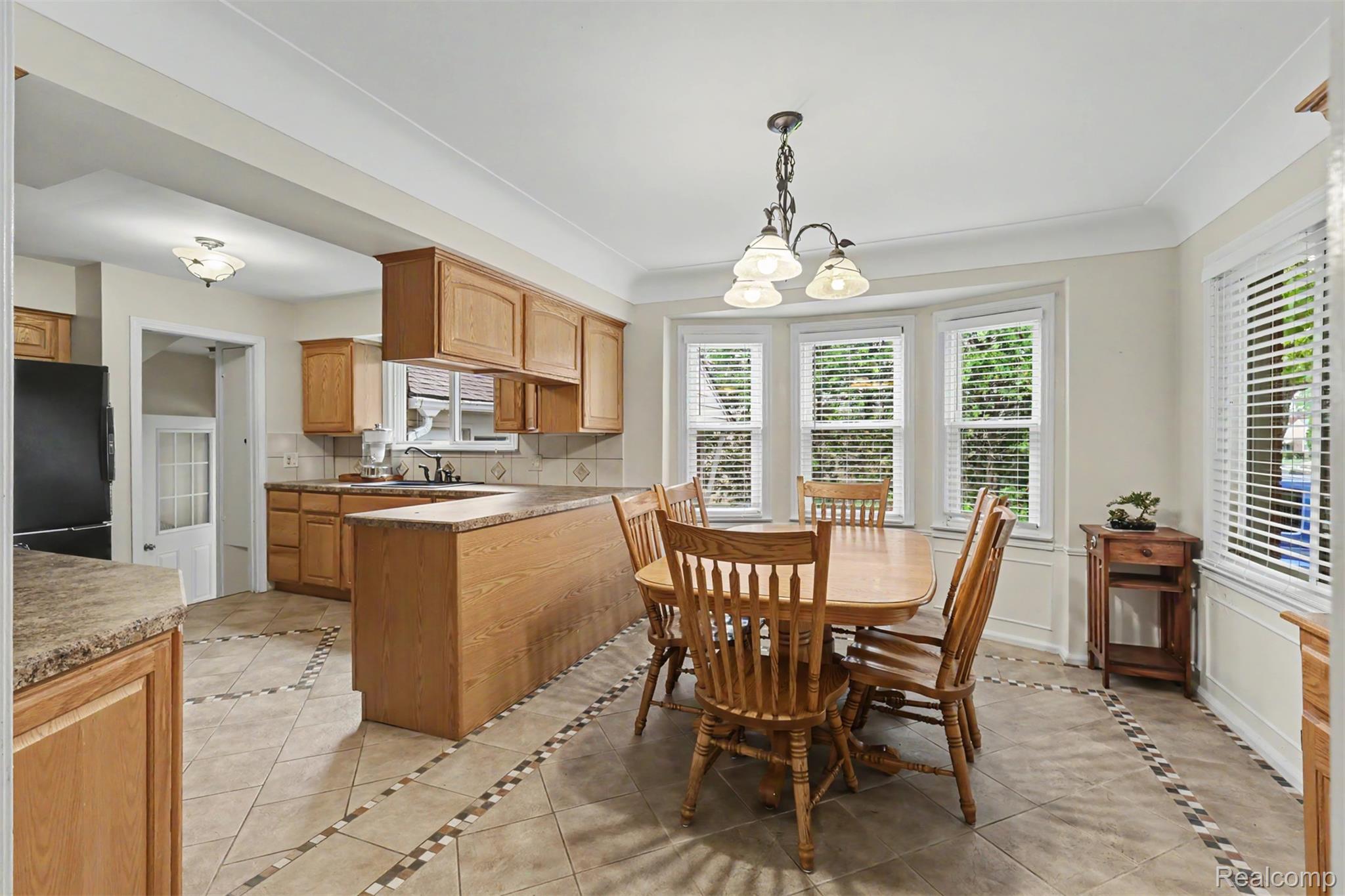 7136 Rosedale Boulevard Allen Park, MI 48101 - Photo 11 of 51 Kitchen with light wood cabinetry, stone-finish countertops, and a tile floor featuring decorative inlay