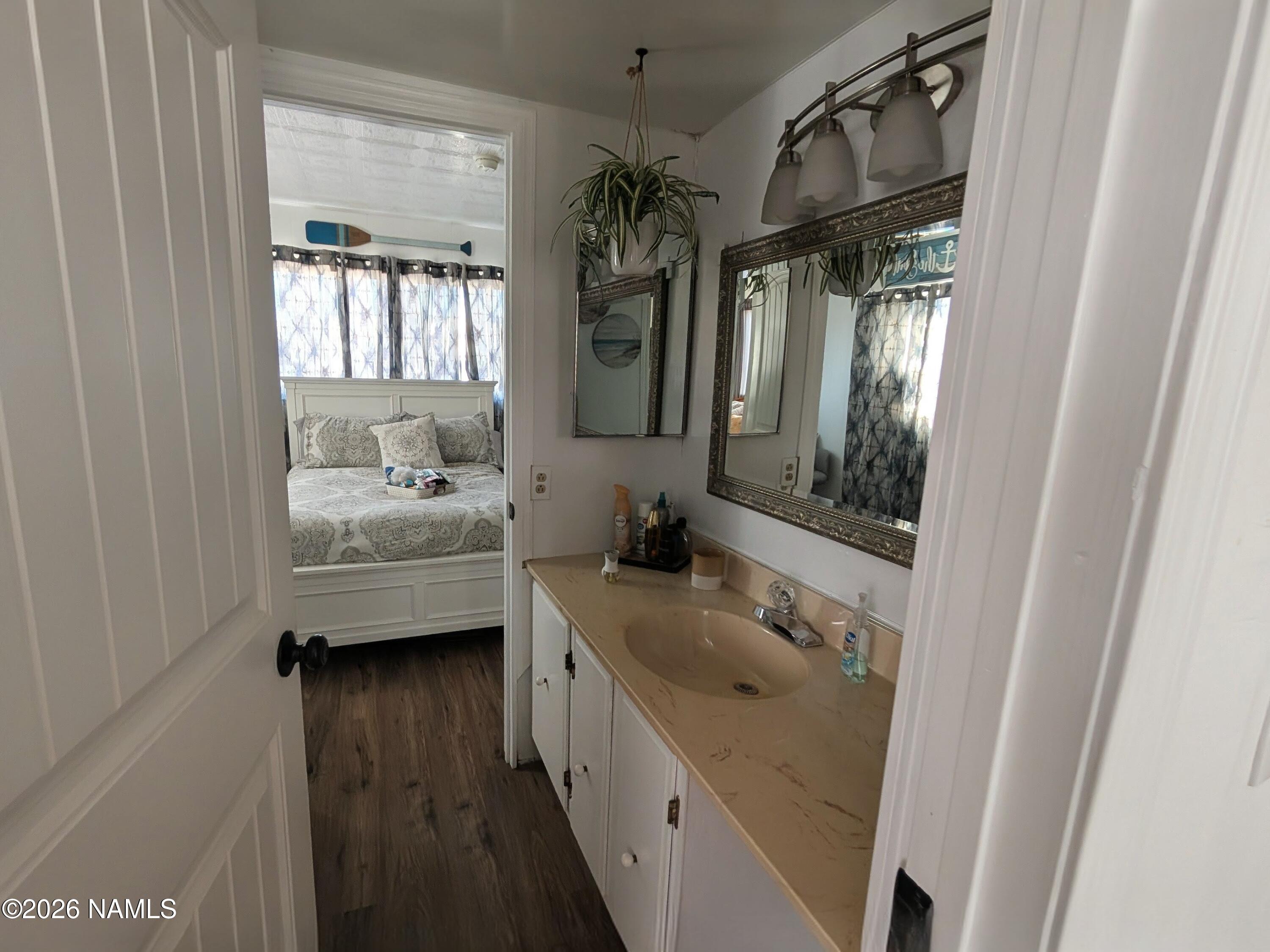 15702 Bonanza Loop Ehrenberg, AZ 85334 - Photo 6 of 13 a bathroom with a sink a mirror and shower