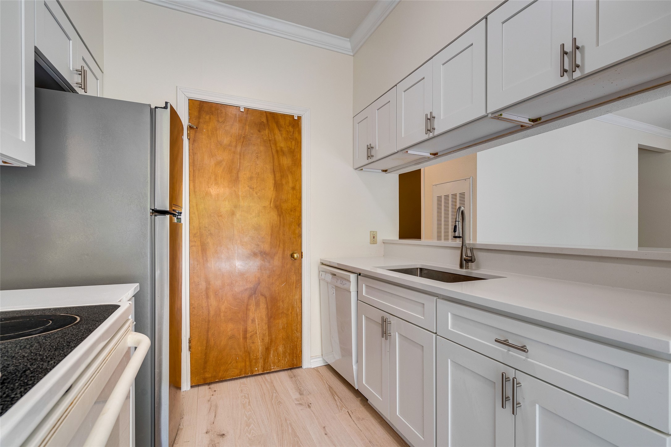 1406 Windsor Road, Unit 201 Austin, TX 78703 - Photo 13 of 32 a kitchen with stainless steel appliances granite countertop a refrigerator and a stove top oven