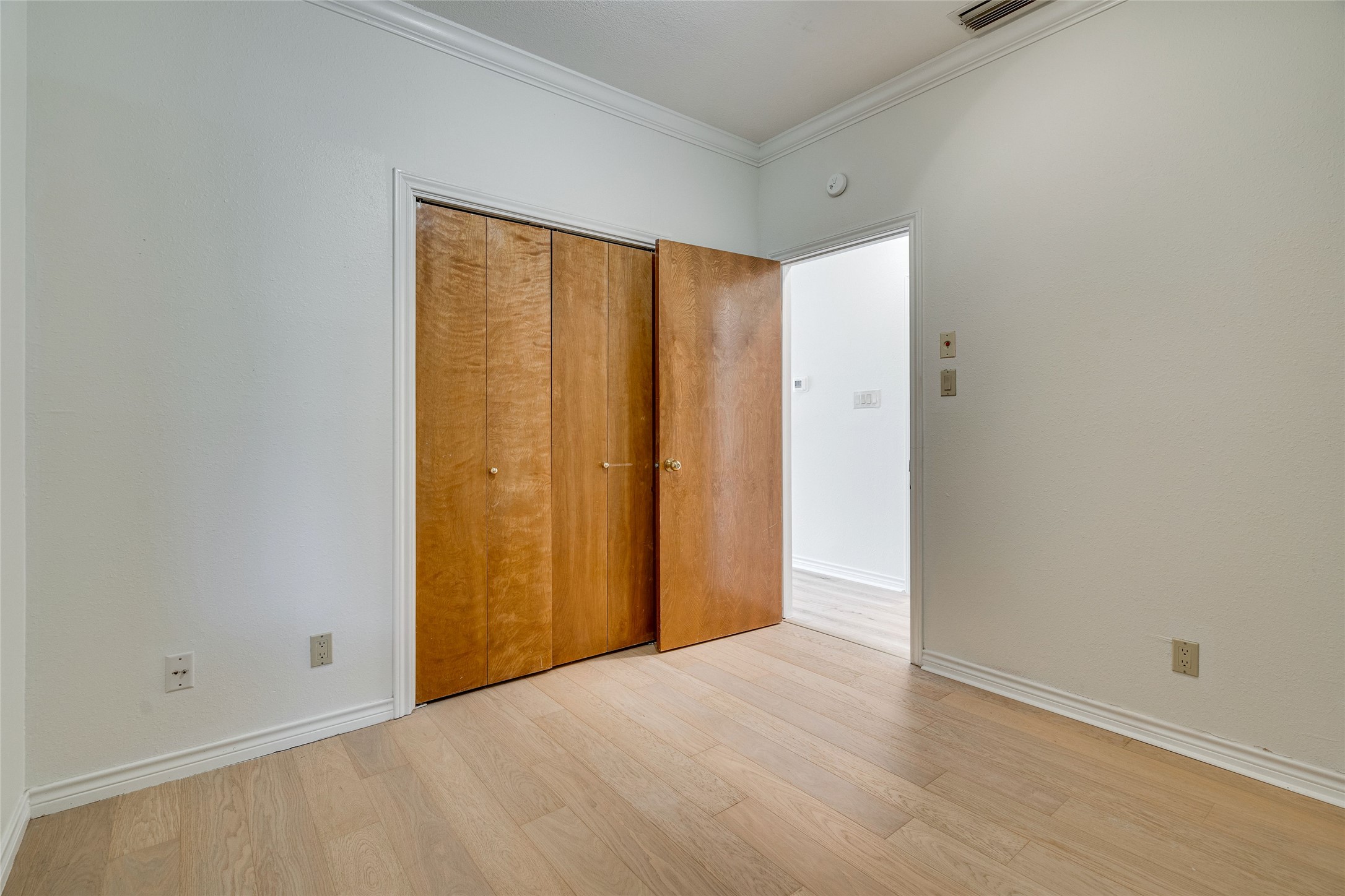 1406 Windsor Road, Unit 201 Austin, TX 78703 - Photo 26 of 32 a view of an empty room with wooden floor