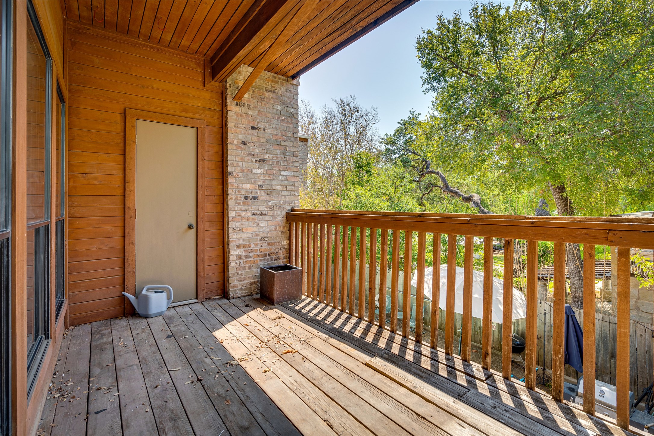 1406 Windsor Road, Unit 201 Austin, TX 78703 - Photo 29 of 32 a view of a balcony with wooden floor