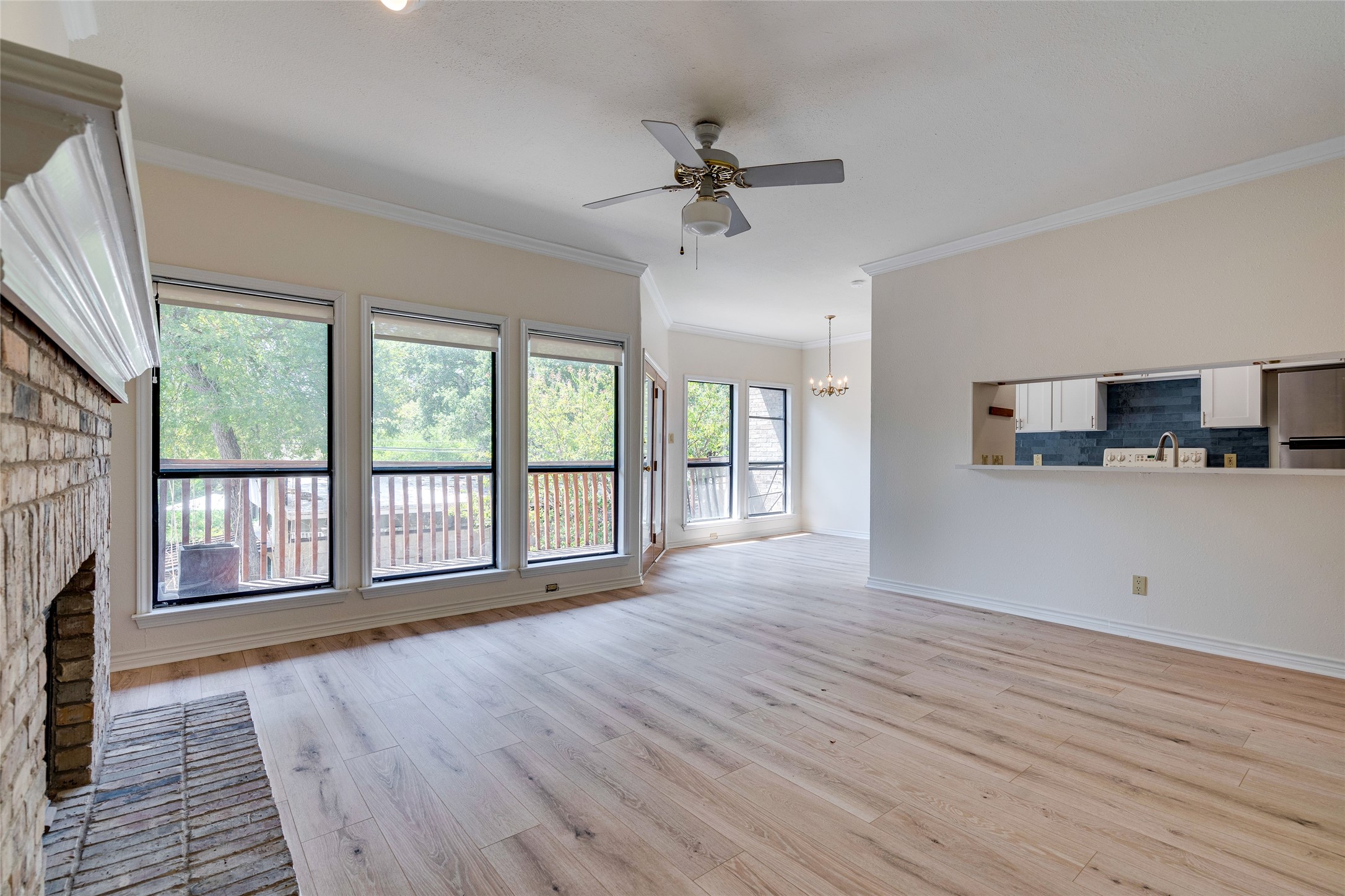 1406 Windsor Road, Unit 201 Austin, TX 78703 - Photo 4 of 32 a view of an empty room with a window and wooden floor