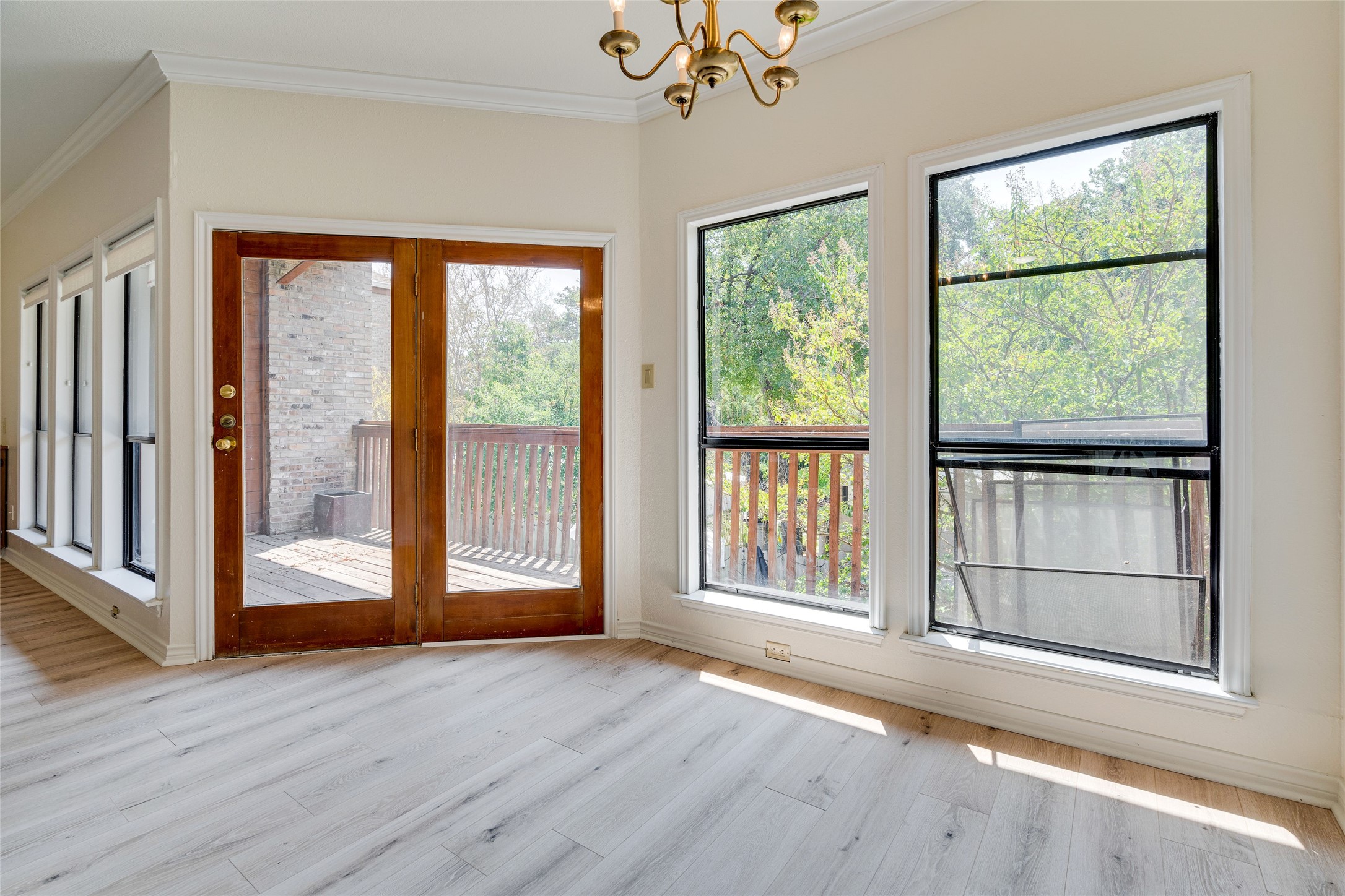1406 Windsor Road, Unit 201 Austin, TX 78703 - Photo 9 of 32 a view of an empty room with wooden floor and a window