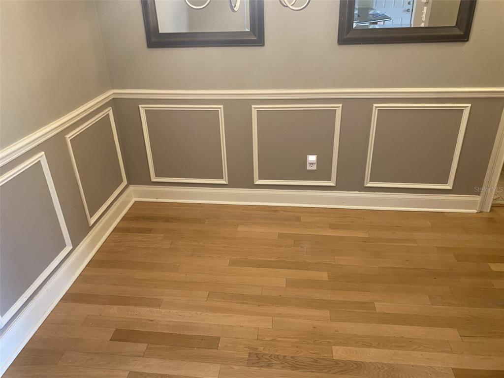 246 Afton Square, Unit 203 Altamonte Springs, FL 32714 - Photo 12 of 26 a view of an empty room with wooden floor and a window
