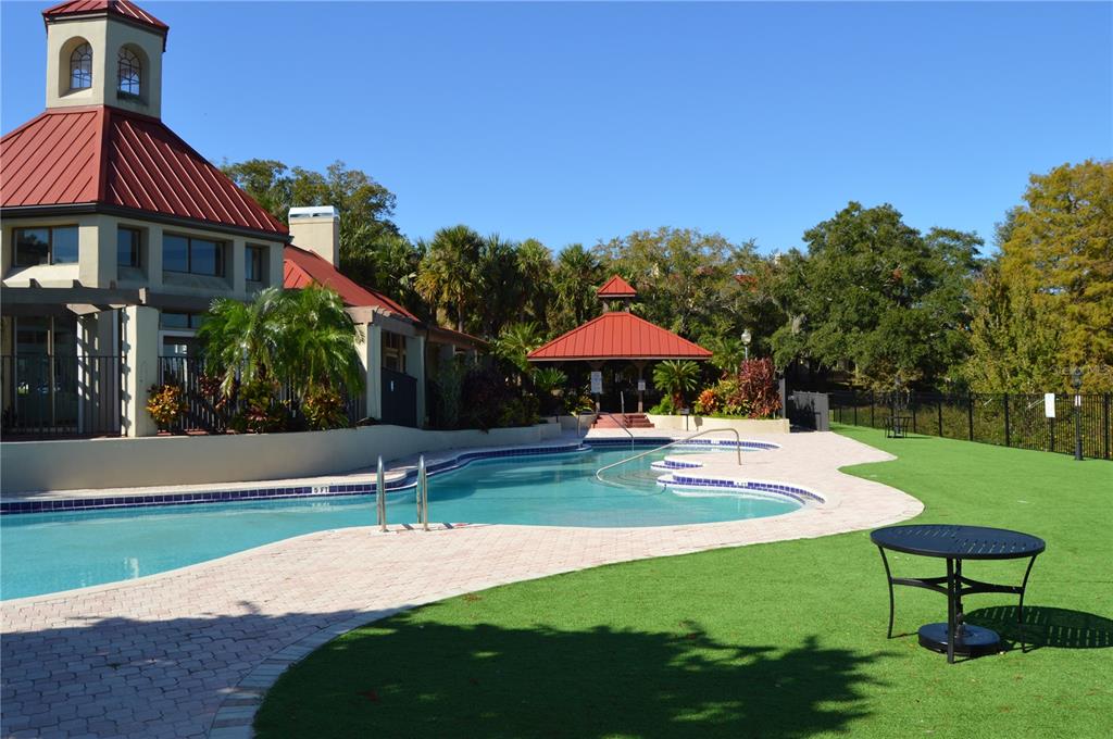 246 Afton Square, Unit 203 Altamonte Springs, FL 32714 - Photo 25 of 26 a backyard of a house with table and chairs