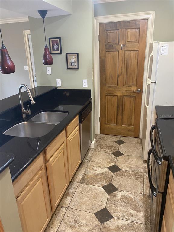 246 Afton Square, Unit 203 Altamonte Springs, FL 32714 - Photo 7 of 26 a kitchen with granite countertop a sink and a stove top oven