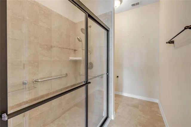a bathroom with a glass shower door