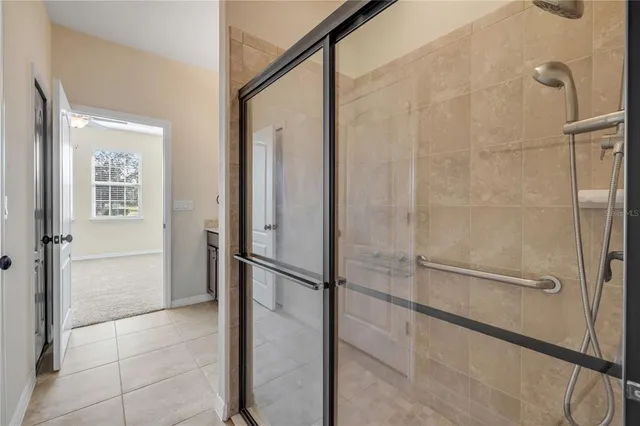 a bathroom with a shower and a glass door