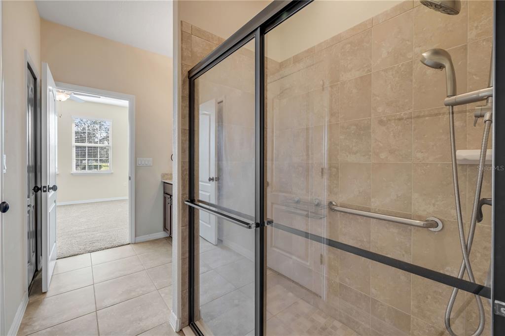 3329 Tuscano Avenue New Smyrna Beach, FL 32168 - Photo 13 of 36 a bathroom with a shower and a glass door