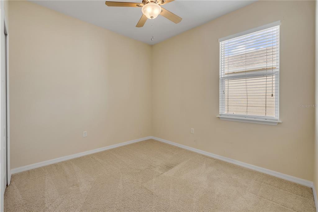 3329 Tuscano Avenue New Smyrna Beach, FL 32168 - Photo 16 of 36 an empty room with a window and a fan