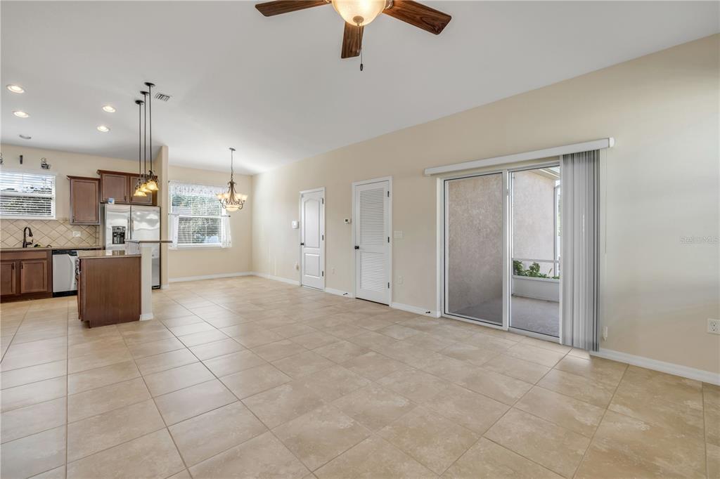 3329 Tuscano Avenue New Smyrna Beach, FL 32168 - Photo 25 of 36 a view of a kitchen with furniture and a ceiling fan
