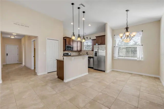 a view of a kitchen with a sink and stainless steel appliances