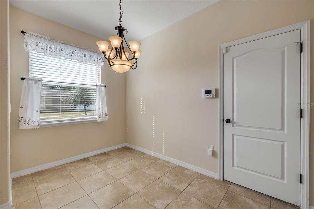 3329 Tuscano Avenue New Smyrna Beach, FL 32168 - Photo 27 of 36 a view of a room with windows and chandelier