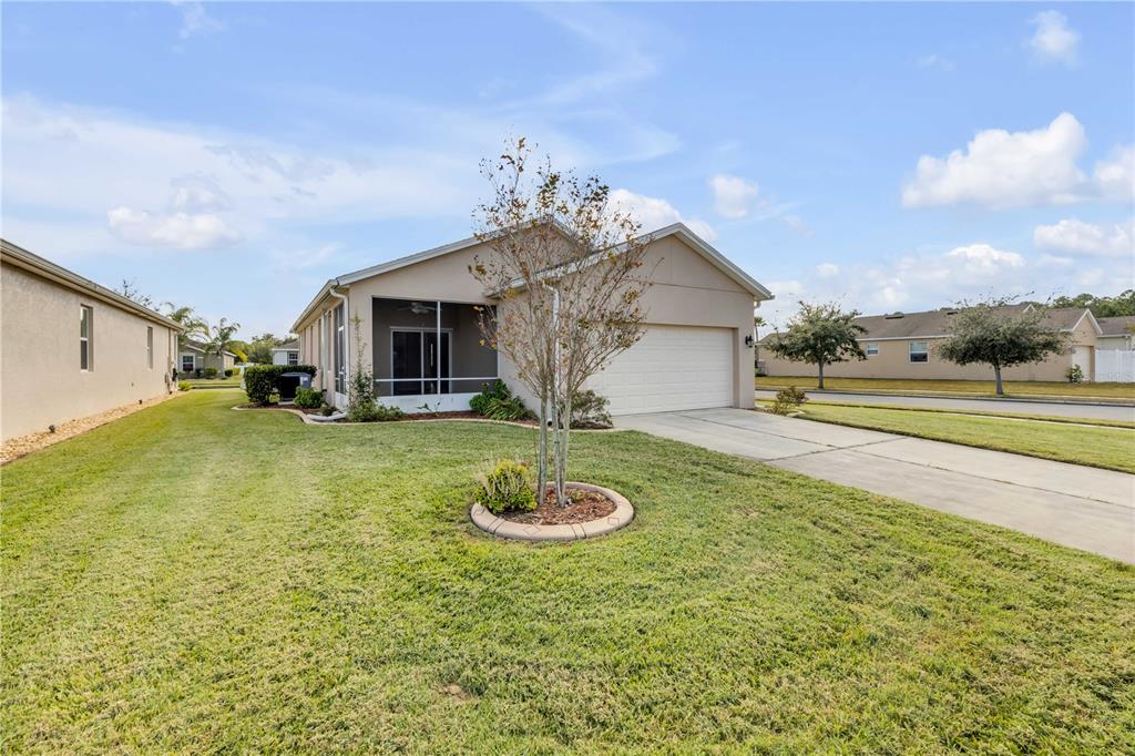 3329 Tuscano Avenue New Smyrna Beach, FL 32168 - Photo 4 of 36 a view of a house with swimming pool and a yard