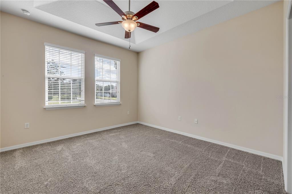 3329 Tuscano Avenue New Smyrna Beach, FL 32168 - Photo 9 of 36 an empty room with a window and a fan